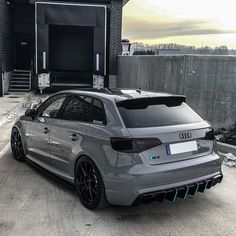 an audi car parked in front of a garage