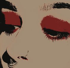 a woman's face with red eyeliners