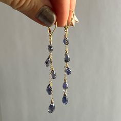 Handmade 14k gold fill Natural Blue Purple Iolite Cascade Earrings.  Long chains.  Iolite jewelry.  Delicate dangles.  September birthday birthstone.  Beautiful, purple blue with tiny, faceted gems.  Delicate cascade of micro faceted small gemstones wire wrapped to the chain which is attached to the lever backs. Iolite or Viking's Compass, is a stone of vision that provides clear communication, universal connections, intuitive understanding of the world.  In yoga it helps in soul exploration.   The earrings are approximately 2.5 inches long.  Each stone is about 5-6 mm to 3-5 mm. each stone is unique, one of kind, you might notice small inclusions in them, they are natural and not considered flaws.  And if you want to see a photo of the stones that are available, I will be happy to send yo Luxury Crystal Jewelry, Blue Gold Bridal Earrings, Cheap Minimalist Blue Jewelry, Gold Purple Jewelry, Michaels Jewelry Diy Ideas, Water Droplet Jewelry, Something Blue Jewelry, Gold Dangly Earrings, Cool Earrings Unique