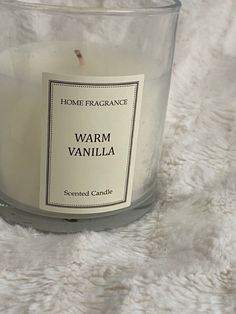 a candle that is sitting on a white blanket