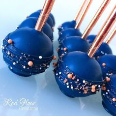 blue cake pops with gold sprinkles on them