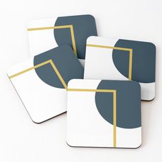 four square coasters with gold and blue designs on white background, set of 4