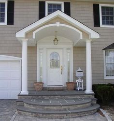 a white front door sitting next to a house