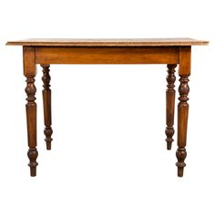 an old wooden table with turned legs and a wood top, isolated on a white background