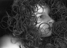 black and white photograph of a woman with curly hair