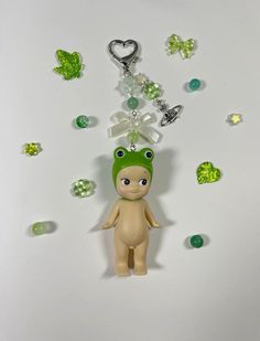 a keychain with a small doll hanging from it's side on a white surface