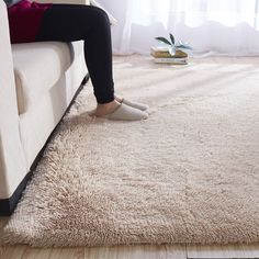 a person sitting on a couch with their feet up