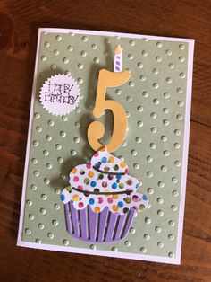 a birthday card with a cupcake on it and the number five candle in the middle