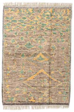 an antique rug with green, yellow and blue colors on it's edges is shown