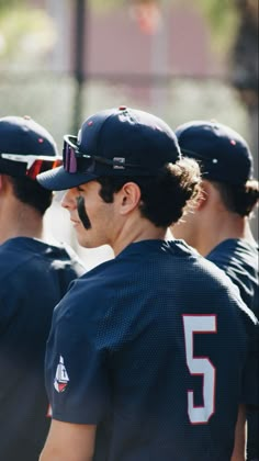 the baseball players are lined up in their uniforms