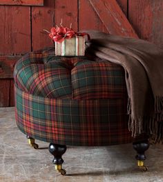 a plaid ottoman with a wrapped present on it