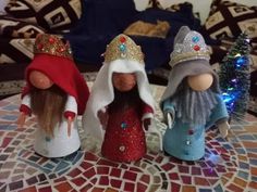 three little gnomes sitting on top of a table