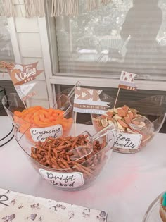 a table topped with lots of food and cupcakes on top of it's sides