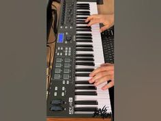 a person playing an electronic keyboard with their hands