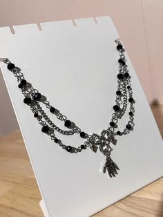 Materials used:  - black faceted beads  - Stainless steel jumprings, lobster claps closure, and spikes  - Zinc alloy skeleton hand charm/chain Black Beaded Necklace, Charm Chain, Black Bead Necklace, Skeleton Hand, Jewelry Black, Skeleton Hands, Choker Necklaces, Steel Jewelry, Stainless Steel Jewelry