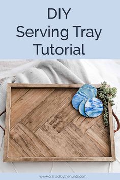 a wooden tray with blue plates on it and text overlay that reads diy serving tray