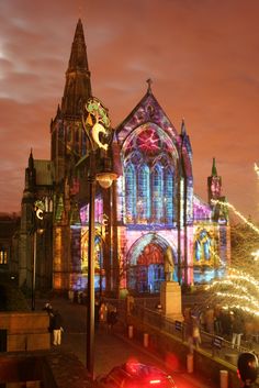 a car parked in front of a church with christmas lights on it