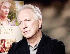 an older man sitting in front of a book with the title chaos written on it