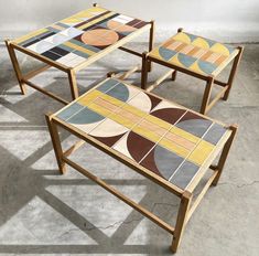 three tables with different colored designs on them