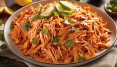 shredded carrots with cilantro and lime on a plate