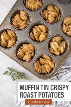 a muffin tin filled with apple pies on top of a white marble counter