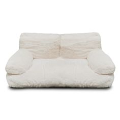 a white couch with two pillows on it