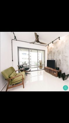 a living room filled with furniture and a flat screen tv on top of a wooden stand