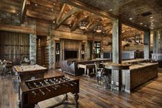 a game room with pool table, foosball and bar