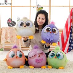 a woman sitting on the floor with four stuffed animals