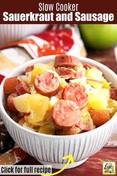 a white bowl filled with cooked sausage and pineapples on top of a wooden table