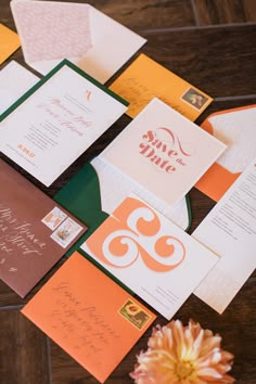 the wedding stationery is laid out on top of each other, including cards and envelopes