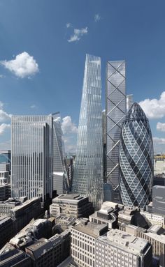 an aerial view of some very tall buildings in the city with blue sky and clouds