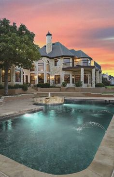 a large house with a pool in front of it