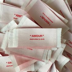 several pieces of cloth with the words amour on them in red and white letters