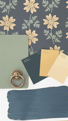 some blue and green paint with flowers on the wall next to it is a gold ring