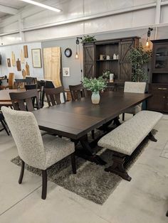 a table and chairs in a room with lots of furniture on the floor around it