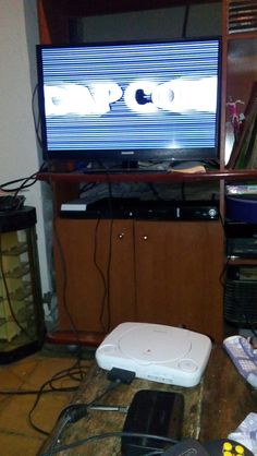 a flat screen tv sitting on top of a wooden table