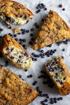 blueberry muffins are cut in half and placed on top of white paper