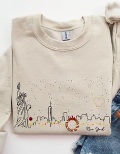 For all those who love NY and experiencing it a Christmas.  This NY skyline sweatshirt shows some of what makes NY so fun.  This unisex heavy blend crewneck sweatshirt is pure comfort. These garments are made from polyester and cotton. This combination helps designs come out looking fresh and beautiful. The collar is ribbed knit, so it retains its shape even after washing. There are no itchy side seams on these sweaters.  .: Made with a medium-heavy fabric blend of 50% cotton and 50% polyester (8.0 oz/yd² (271.25 g/m this sweatshirt feels cozy and is the perfect choice for those colder months. .: The classic fit along with the crew neckline deliver a comfy wearing experience with a clean-cut style. Meanwhile, the double-needle stitching at the shoulder, armhole, neck, waistband, and cuff s Ny Skyline, New York Shirt, I Love New York, Wonderful Time Of The Year, Cute Sweatshirts, Clean Cut, Christmas Sweatshirts, Time Of The Year, Wonderful Time