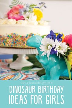 dinosaur birthday ideas for girls with flowers in the vase and cake on the table behind it