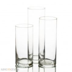 three clear glass vases sitting next to each other