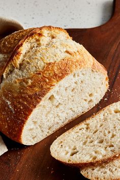 a loaf of bread sitting on top of a wooden cutting board