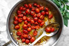 a pan filled with lots of tomatoes on top of a table