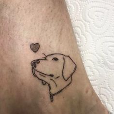 a dog with a heart tattoo on its leg