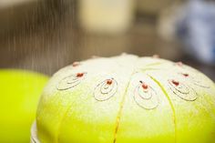 a close up view of some tennis balls with drops of water coming from the top