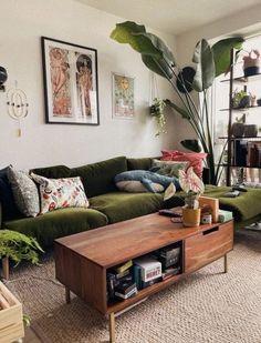 a living room filled with lots of furniture next to a large green plant on top of a wooden coffee table