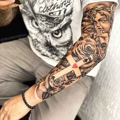 a man with a cross and roses tattoo on his arm