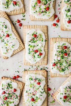 some cookies are decorated with white icing and sprinkles