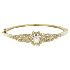 Simply exquisite Victorian era inspired bangle. Hand crafted as unique of solid 14k yellow gold. Charming flower of pearl centered by an approx. 2 carat pearl with further seed pearl chasing the sides. The is the design that a lady of the Victorian period used to wear on her wrist, one of the most desired then and today. Bracelet Information Style: Victorian Metal: 14K Yellow Gold Width: 14 mm. Length:46 mm. Weight: 12.30 g. (approx. in total) Center Gemstones Type: Fresh water Pearl Shape: Roun Victorian Period, Bracelet Box, Fresh Water Pearl, Seed Pearl, 2 Carat, Victorian Era, Victorian Fashion, Bangle Bracelet, Fresh Water