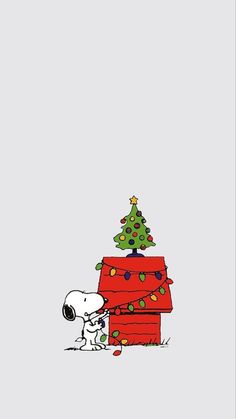 snoopy and his christmas tree on top of a house